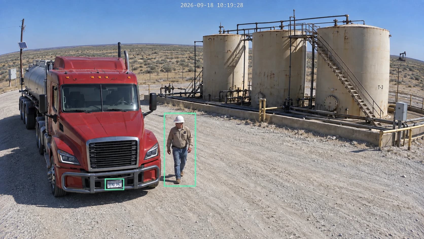 Oilfield scene with detection boxes around a worker and the demo license plate of a red truck beside storage tanks.