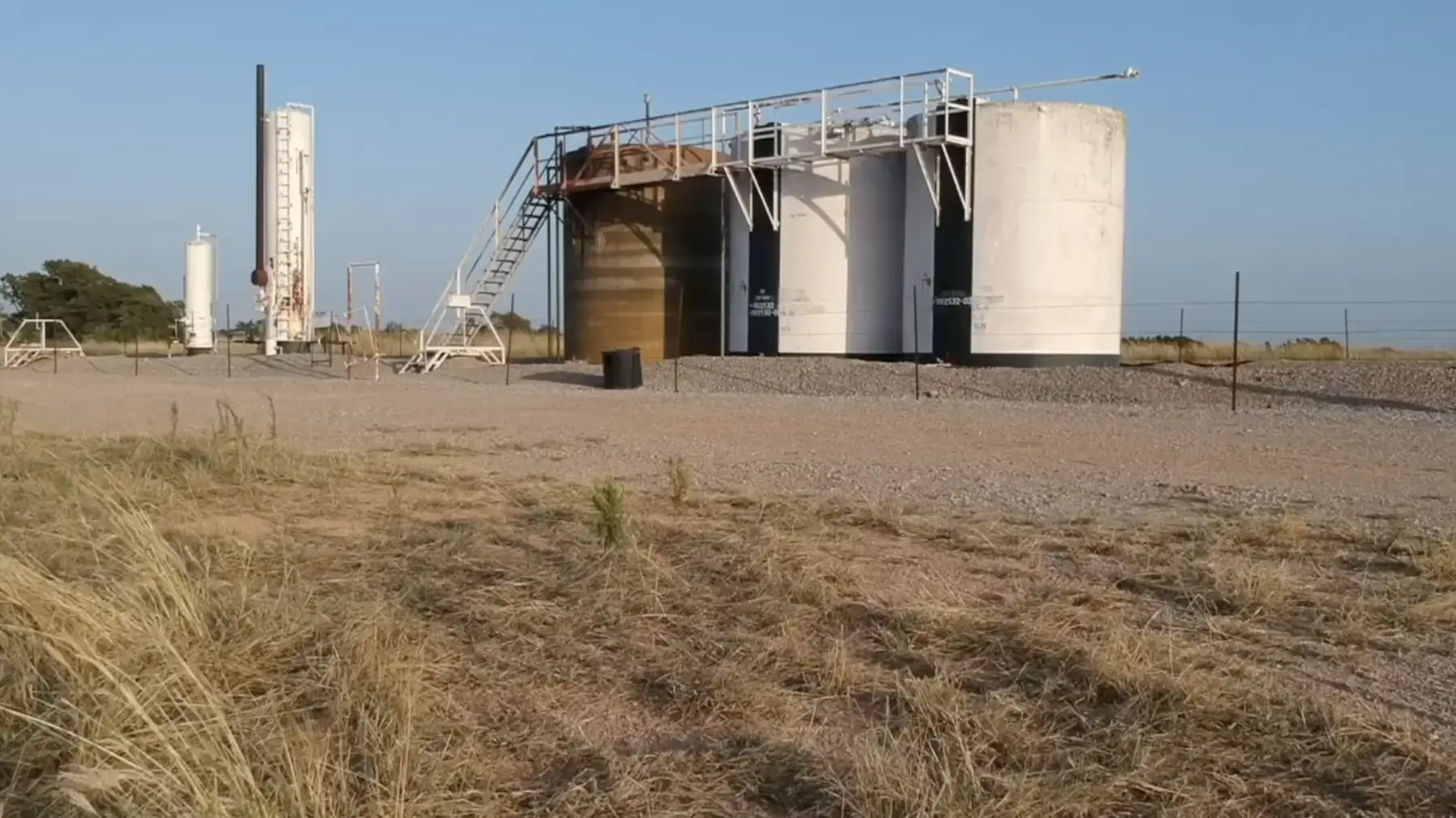 Storage tanks and piping at an oilfield tank battery